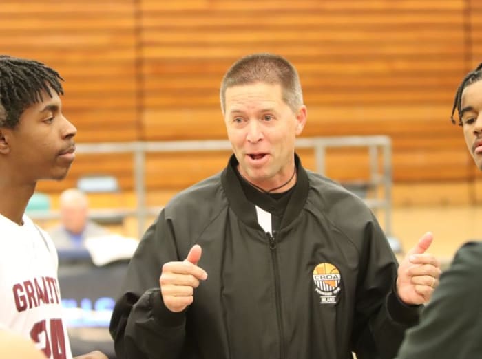 Official Dan Van Gorp chats with the team captains before a recent game.